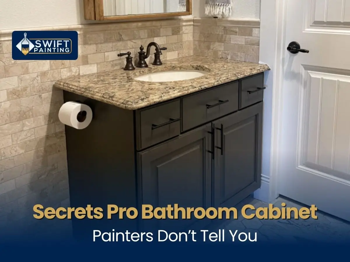 Modern dark charcoal painted bathroom vanity cabinet with a granite countertop and stone tile backsplash.