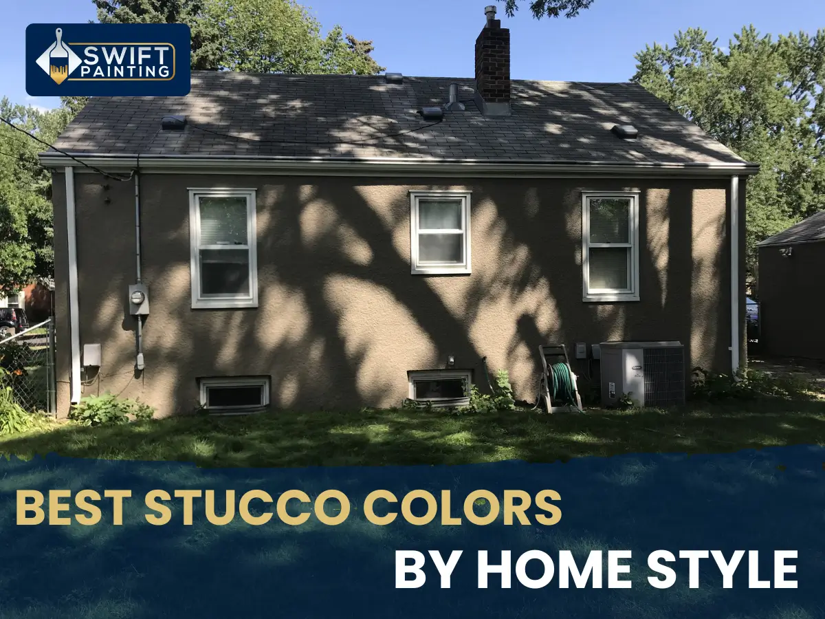 Back exterior of a painted taupe stucco house showing basement windows and tree shadows.